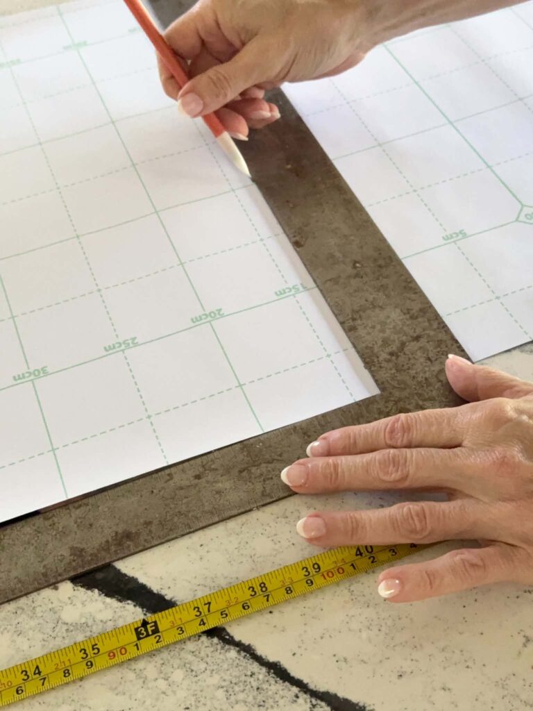 Measuring wallpaper before cutting.
