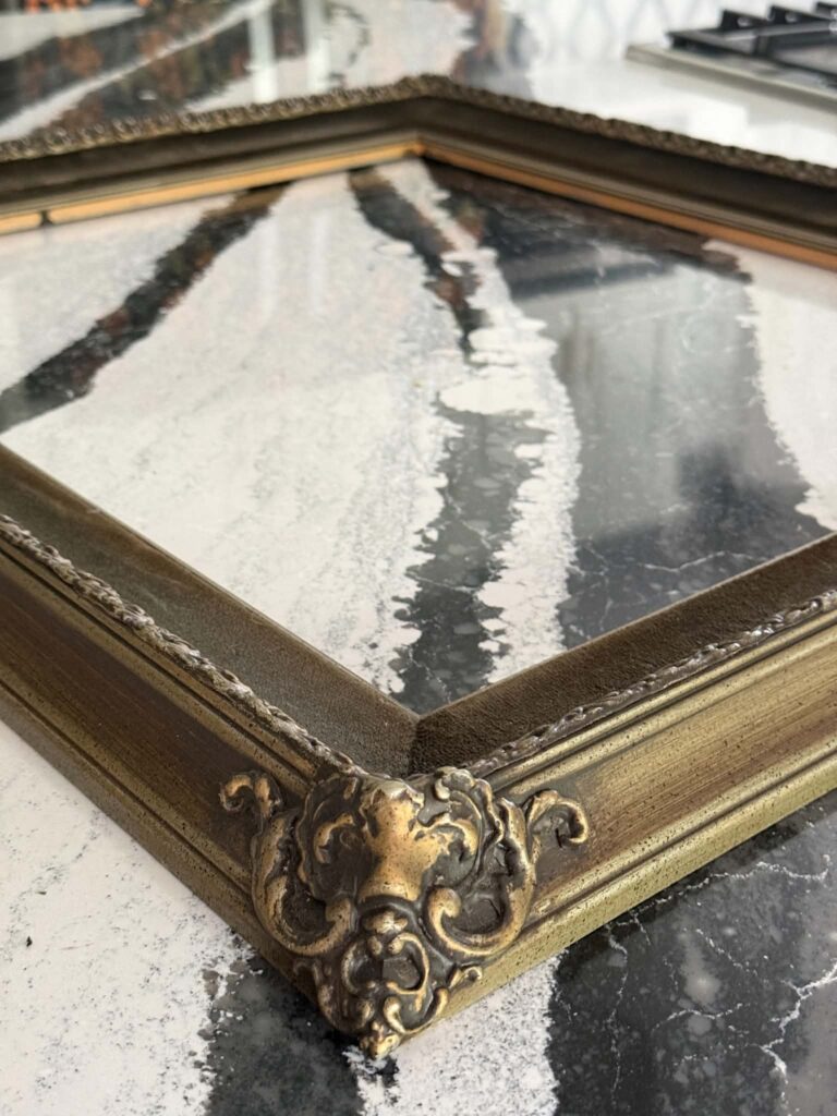 An old ornate frame to be repurposed as garden art.
