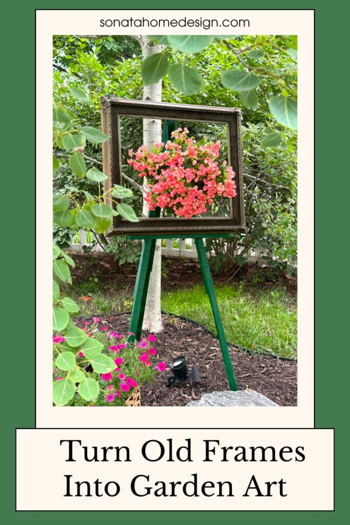 Old picture frame turned into garden art with a wood easel and hanging basket of begonias.