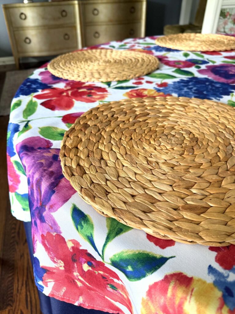 Woven placemats on a summer tablecloth.