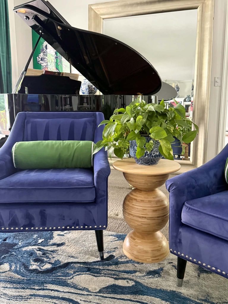 DIY IKEA bowl side table between two blue chairs in a living room.