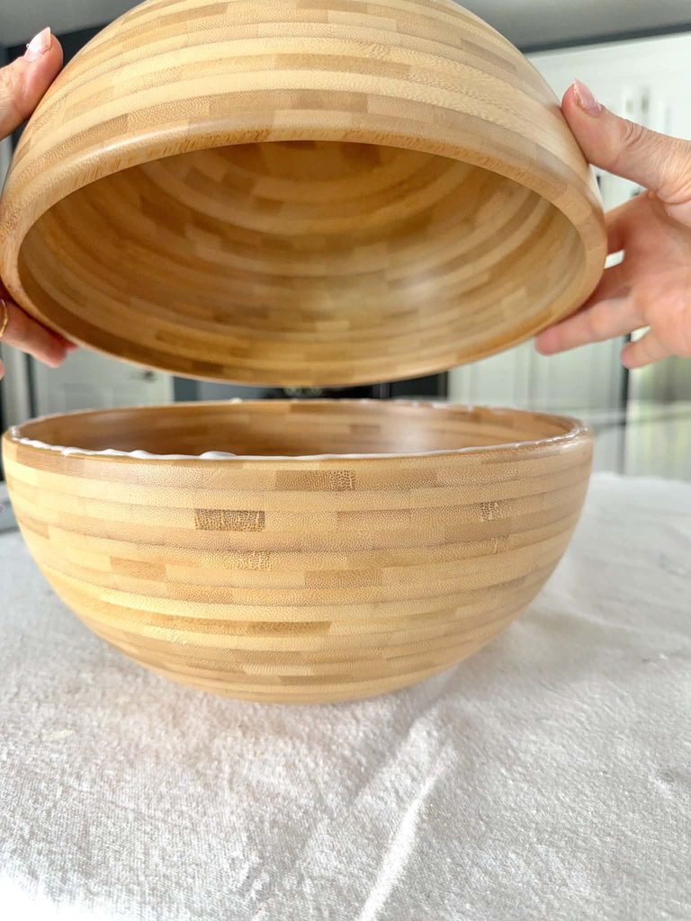 Gluing two IKEA salad bowls together for a side table DIY project.