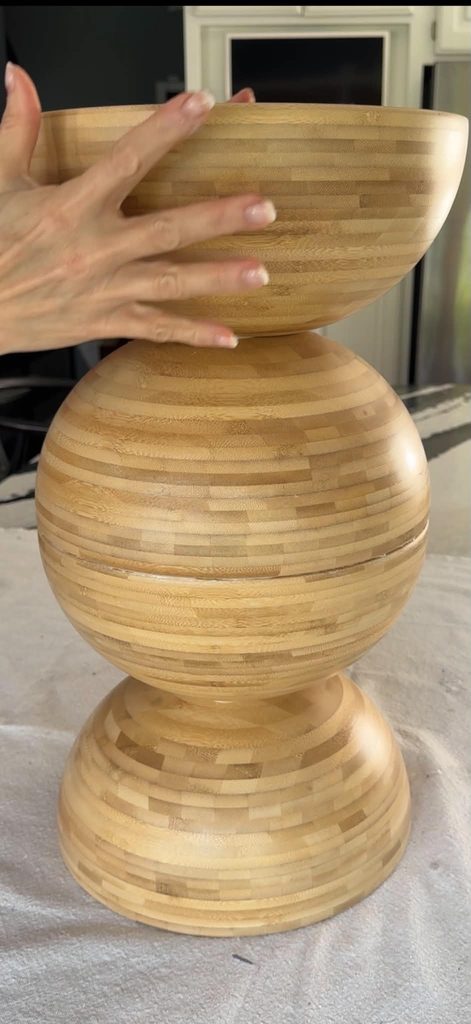 Gluing a bowl on to of a bowl ball for a DIY side table hack.
