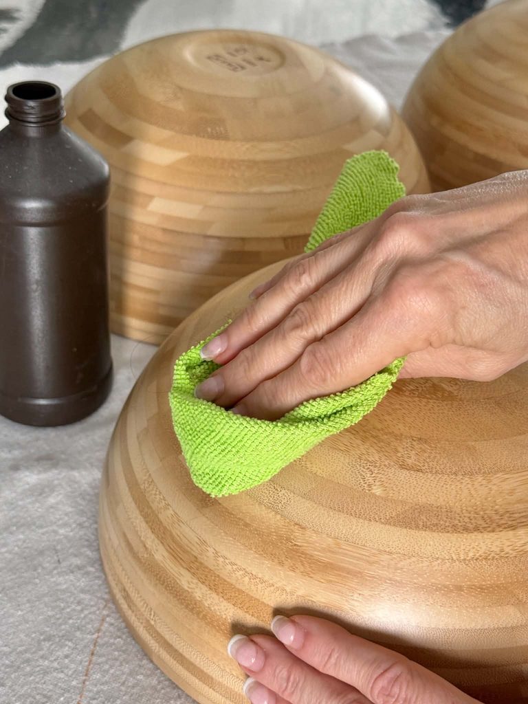 Cleaning a wood bowl with rubbing alcohol.