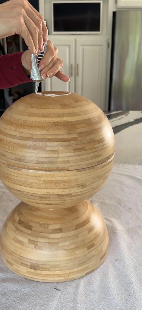 Applying E6000 glue to the top of a wooden ball created with IKEA BLANDA MATT bowls.