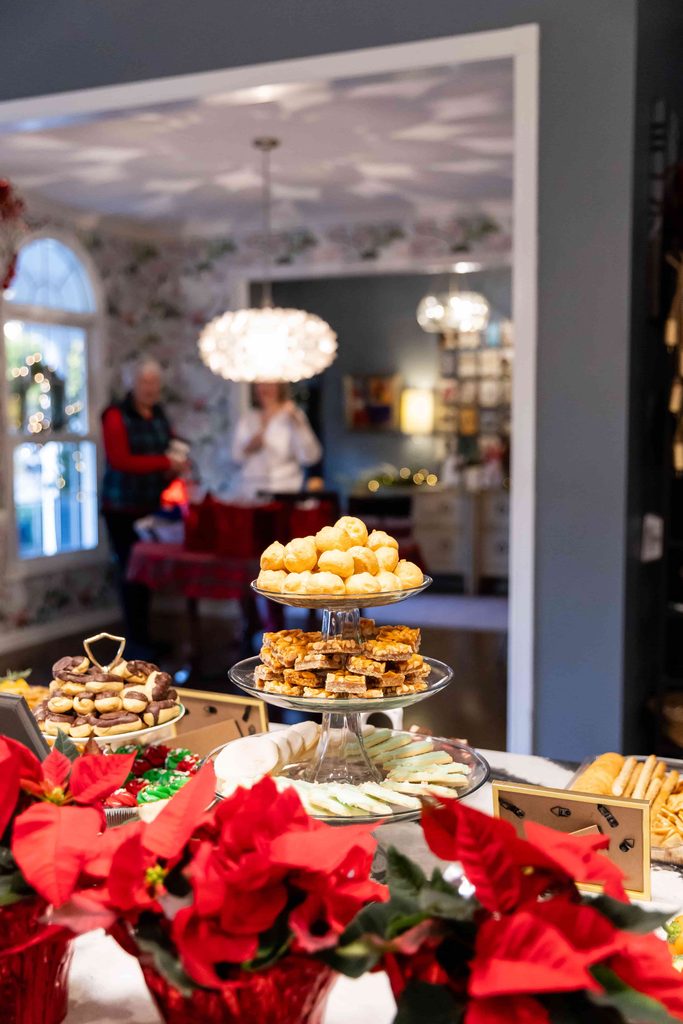 A Christmas buffet with tiered trays of sweets and cookies.