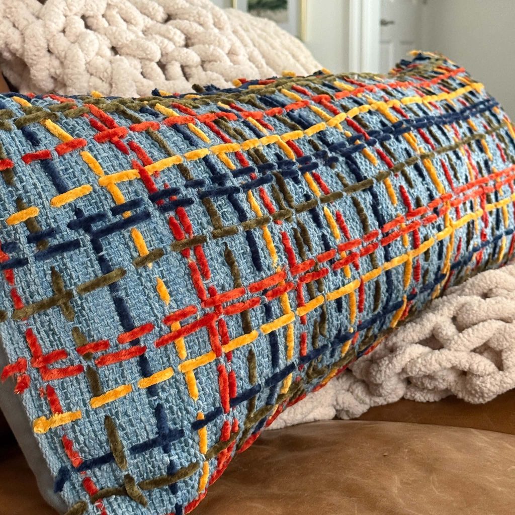 A throw pillows decorated with yarn.