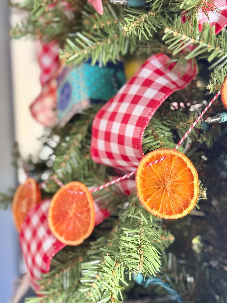 A Christmas tree garland made from dried orange slices.