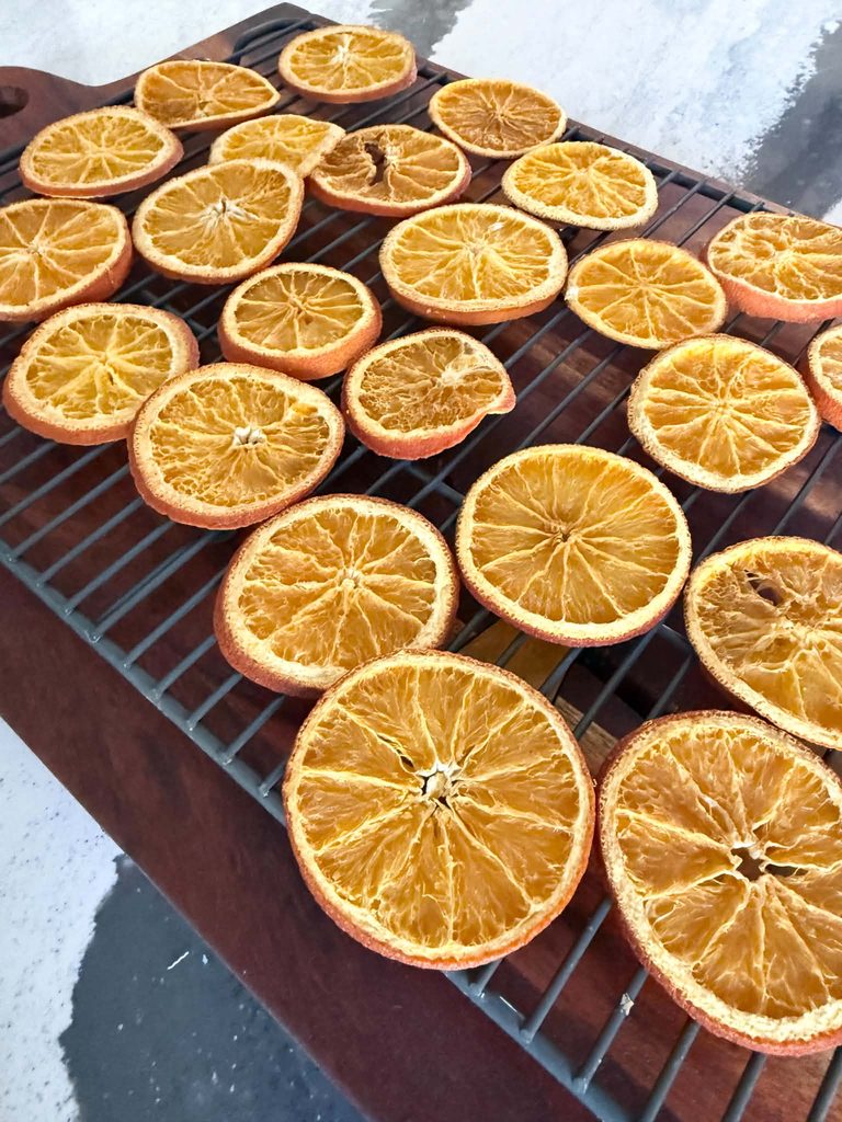 Dried orange slices on a cooking rack.