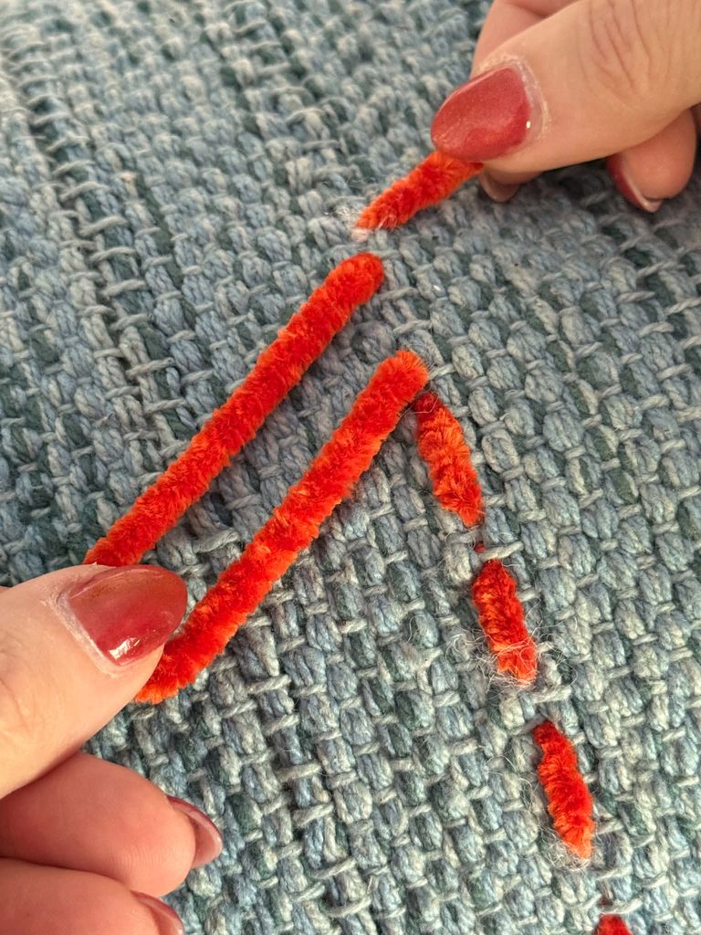 Stitching and decorating throw pillows with yarn.