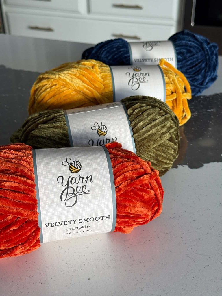 Four skeins of chenille yarn.