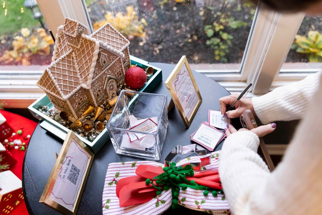 A woman writing her name on a card for a holiday giveaway.